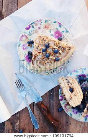 Slice of delicious cake with fresh blueberry on wooden backgroup. Piece of blueberry cake, piece of