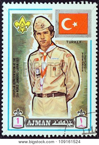 AJMAN EMIRATE - CIRCA 1971: A stamp printed in United Arab Emirates shows boy scout from Turkey
