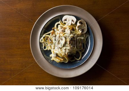 Fancy organic fetuccine pasta with creamy alfredo mushroom sauce