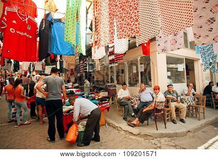 Old Market And Many Seniors Sitting And Talking At Street Cafe Of Turkish Village