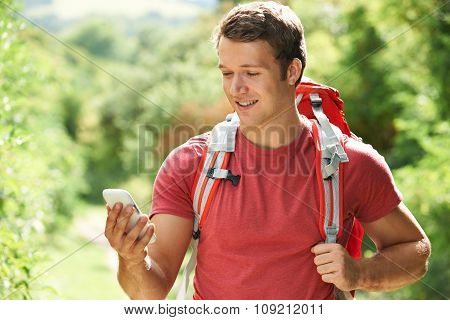 Man Checking Location With Mobile Phone On Hike