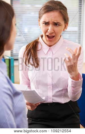 Aggressive Businesswoman Shouting At Female Intern