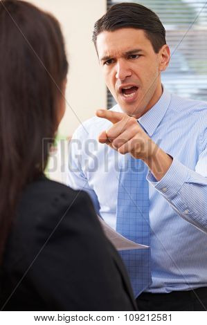 Aggressive Businessman Shouting At Female Colleague