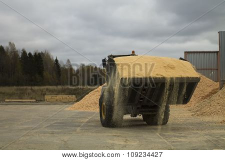 Auto Loader With Scoop Full Of Sawdust
