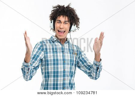 Portrait of a cheerful man in headphones looking at camera isolated on a white background