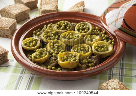 Traditional Moroccan tagine with meat, artichoke hearts and green peas