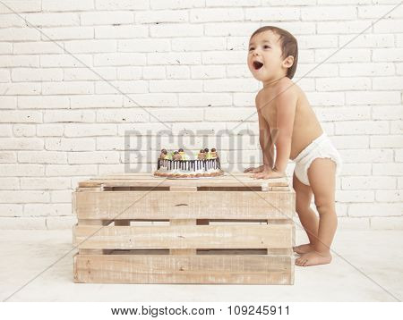 Cheerful Toddler And His Cake On Wooden Box