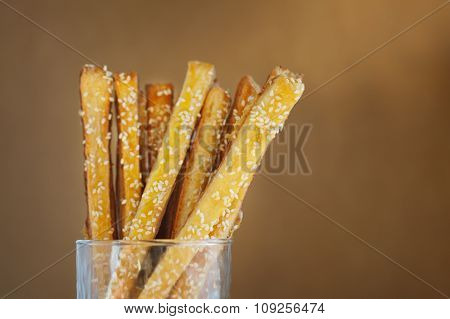 Bread Sticks With Cheese And Sesame In The Glass, Close Up