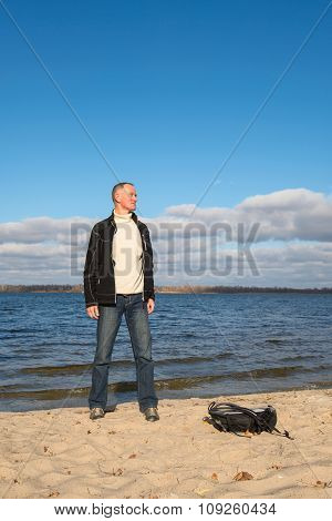 Joyful Hiker Man Standing On The Coast, Looking Into The Distanse, Relaxing And Smiling