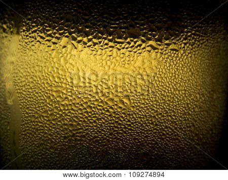 Condensed water drops on the glass with ice cold juice or beer