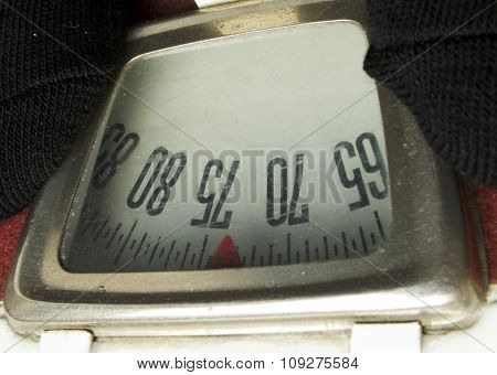 Old dusty weighing machine. 75 kilos
