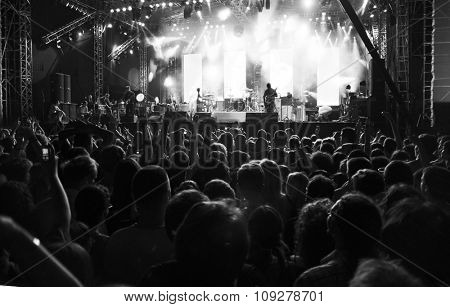 Rock music band playing on a concert stage.