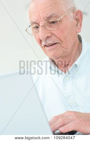elderly man with a laptop