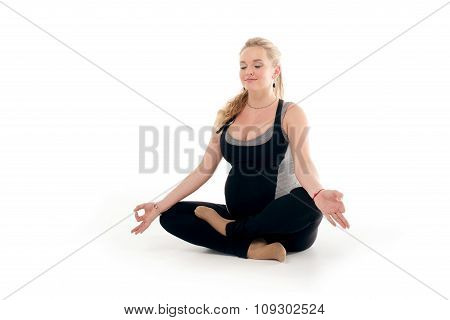 Pregnant woman doing sport exercises in yoga style