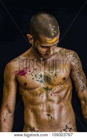 Handsome young man painted and sprayed with Honi color on his skin