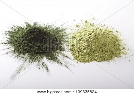 Spirulina and barley grass raw powder on white background - heap.