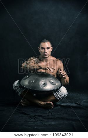 Male Drummer Drumming on Steel Drums in Studio