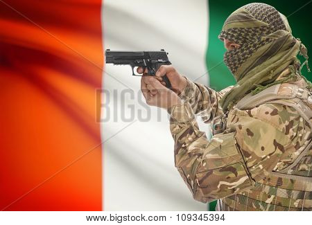 Male In With Gun In Hand And National Flag On Background - Ivory Coast
