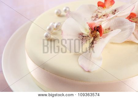 Cake with sugar paste flowers, on light background