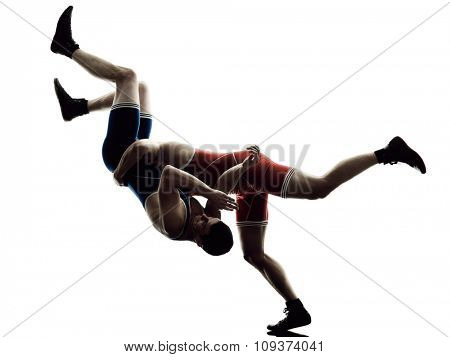 two caucasian wrestlers wrestling men on isolated silhouette white background
