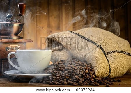 still life with coffee beans and old coffee mill on the wooden background 