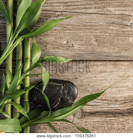 zen basalt stones and bamboo on the wooden baord background
