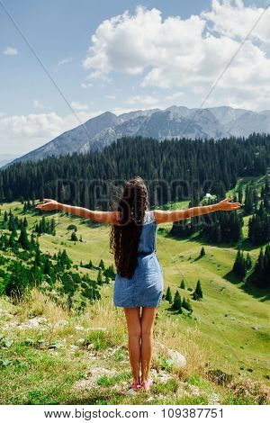 Woman Relax And Stand Hands Up On Peak Of Mountain
