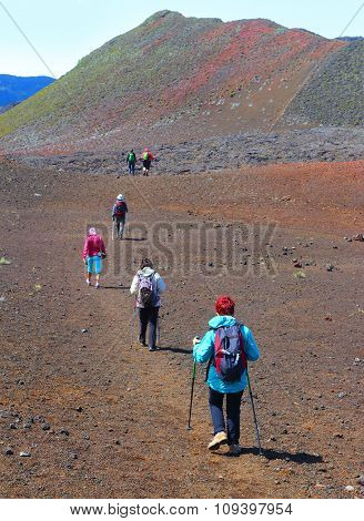Group of hikers walking on Piton de la Fournaise (Peak of the Furnace) 2632m. Reunion island, France.