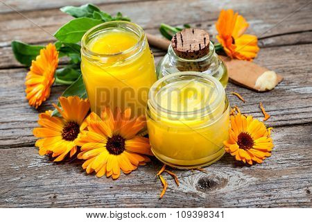 Homemade calendula ointment on wooden table