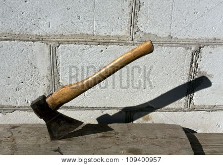 Old Axe In Wood Plank.