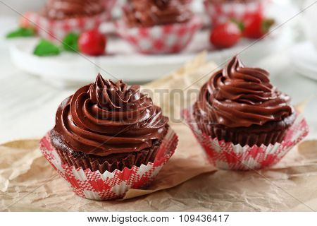Chocolate cupcakes on craftpaper closeup
