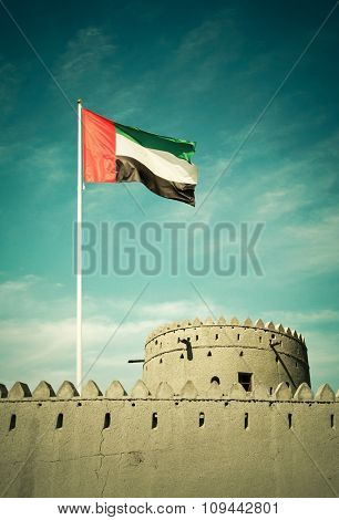 United Arab Emirates flag hoisted on an ancient burj.