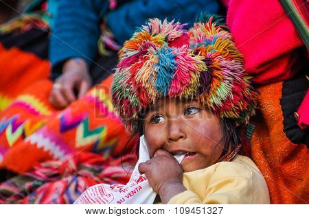 Quechua Girl Chewing Something In A Village In The Andes, Ollantaytambo, Peru