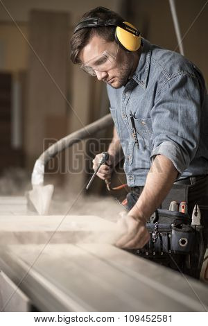 Woodworker Wearing Muffs And Glasses