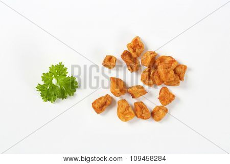 group of pork greaves on white background