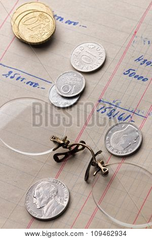 rimless glasses and different coins over calculus