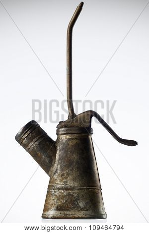 an old, rusty oiler against gray background