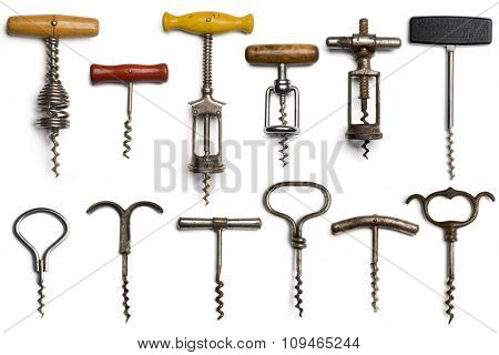 a collection of dozen vintage corkscrews on white