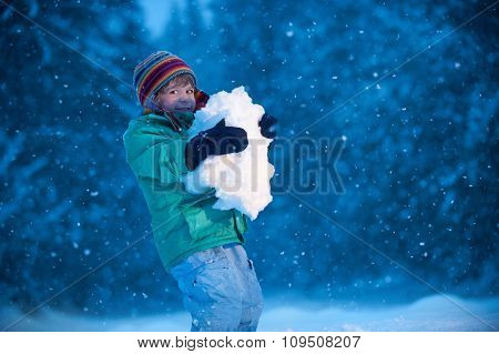 Little boy playing in snow