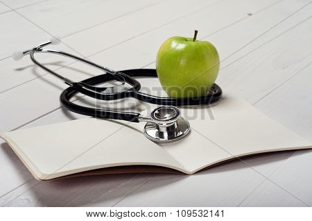 Open Notebook With Blank Pages With Stethoscope And Aplle