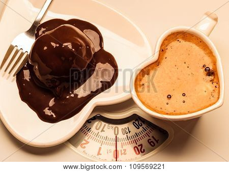 Coffee And Chocolate Cake On Weighing Scale.