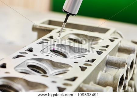 Close-up check measurement of metal detail by precision detecting head sensor at metalworking manufacture in factory 