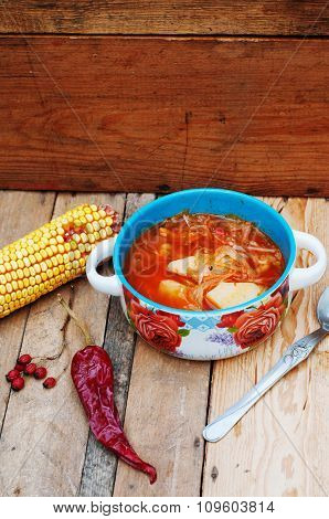 Traditional Ukrainian Russian vegetable borscht on the old wooden background. Ukrainian and russian