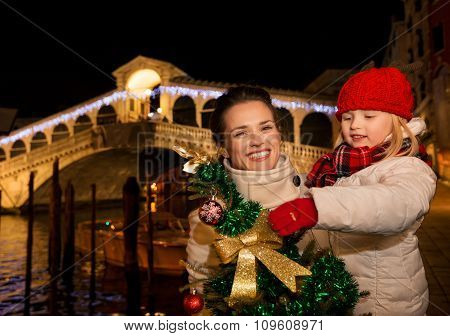 Happy Mother And Daughter With Christmas Tree In Venice, Italy.