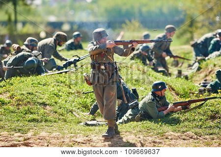 LOSHANY, BELARUS - MAY 10: Re-enactment of the WWII attack battle by history club members as German Nazi soldiers during historical show at Stalin Line memorial on May 10, 2015 in Loshany, Belarus
