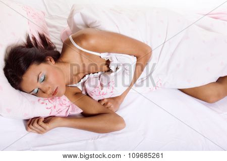 Young woman laying and sleeping on the bed