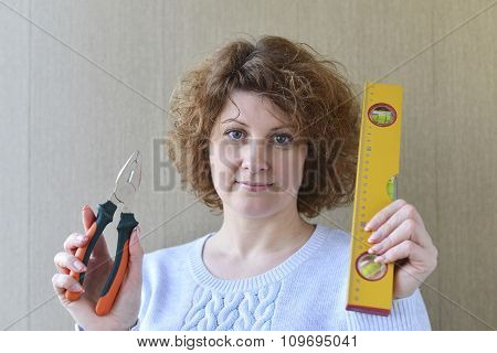 woman is holding construction tools