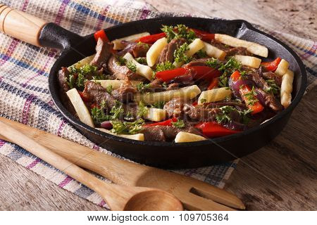 Homemade Peruvian Cuisine: Lomo Saltado In A Pan Close-up Horizontal