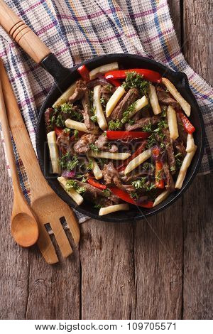 Peruvian Food: Lomo Saltado In A Frying Pan. Vertical Top View