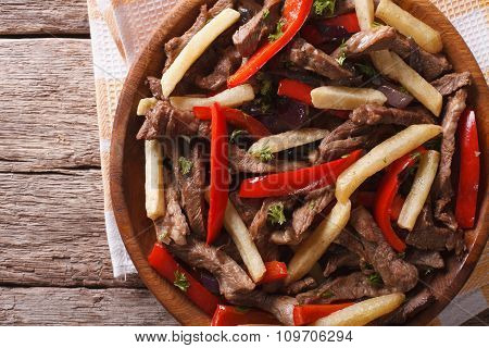 Peruvian Cuisine: Lomo Saltado Close-up On A Plate. Horizontal Top View